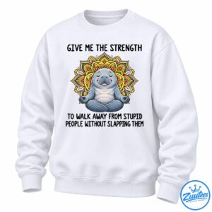 Gray-blue meditating manatee with closed eyes and a colorful yellow, orange, red, and green mandala design.
