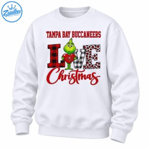 Green Grinch holding a red heart with Tampa Bay Buccaneers text, plaid LOVE letters, leopard spots, and red Christmas script