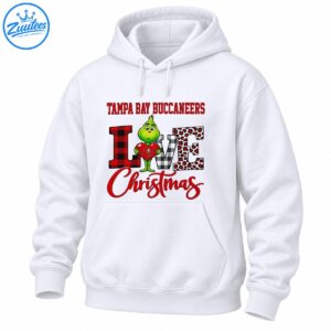 Green Grinch holding a red heart with Tampa Bay Buccaneers text, plaid LOVE letters, leopard spots, and red Christmas script