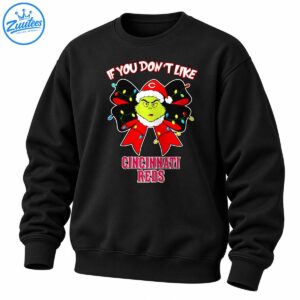 Grumpy green Christmas character in a Santa hat on a red and black bow with colorful lights and Cincinnati Reds lettering