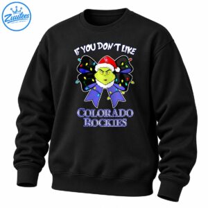 Grumpy green Christmas character in a Santa hat with a purple bow, colorful lights, and Colorado Rockies lettering
