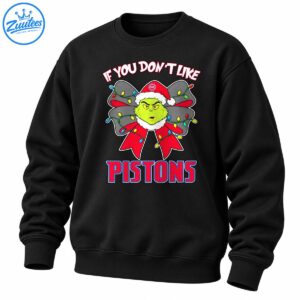 Green grumpy Christmas character in a Santa hat with a festive lighted bow and bold red and blue PISTONS lettering