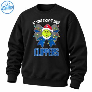 Green grumpy holiday character in a red Santa hat with a blue Christmas bow, colorful lights, and bold Clippers lettering