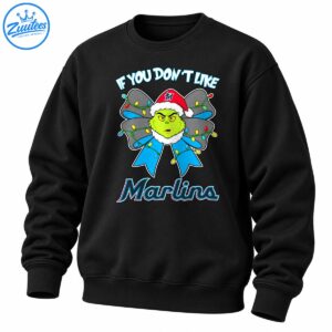 Grumpy green Christmas character in a Santa hat with a blue bow and colorful lights, with Marlins lettering