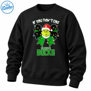 Grumpy green Grinch in a red Santa hat inside a black and green Christmas bow with colorful lights and Milwaukee Bucks lettering