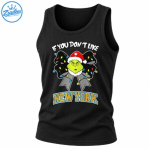 Grumpy green Christmas character in a Santa hat on a black light-covered bow with white text and bold New York lettering