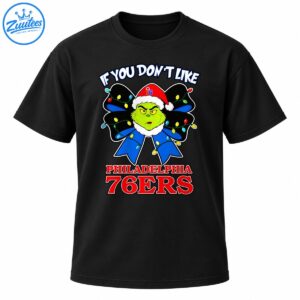 Grinch wearing a red Santa hat with a blue Christmas bow, colorful lights, and Philadelphia 76ers lettering
