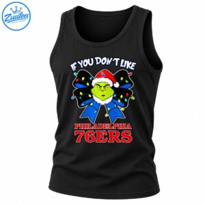 Grinch wearing a red Santa hat with a blue Christmas bow, colorful lights, and Philadelphia 76ers lettering