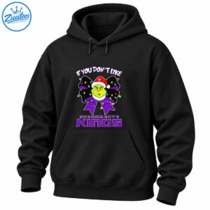 Grumpy green Christmas character in a Santa hat with a purple bow, colorful holiday lights, and Sacramento Kings lettering