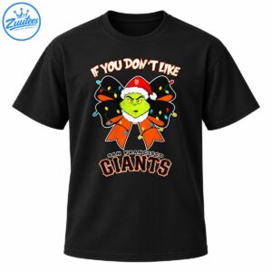 Grumpy green character in a red Santa hat with a black and orange Christmas bow, colorful lights, and San Francisco Giants lettering