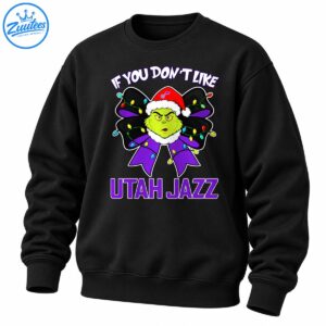 Grumpy green holiday character in a Santa hat on a purple bow with colorful Christmas lights and Utah Jazz lettering