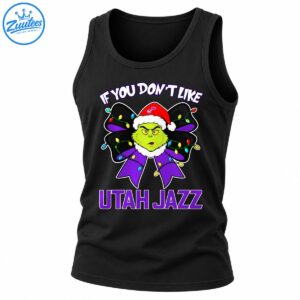 Grumpy green holiday character in a Santa hat on a purple bow with colorful Christmas lights and Utah Jazz lettering