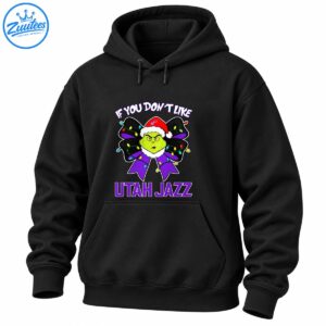 Grumpy green holiday character in a Santa hat on a purple bow with colorful Christmas lights and Utah Jazz lettering
