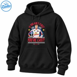 Talladega racing graphic with a driver holding a helmet, checkered flags, gold stars, and red If You Ain’t First You’re Last lettering