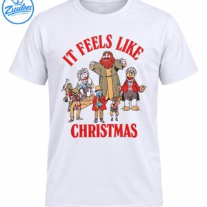 It Feels Like Christmas shirt design with red vintage lettering and a cheerful group of colorful holiday characters
