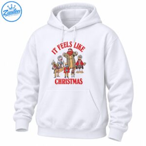 It Feels Like Christmas shirt design with red vintage lettering and a cheerful group of colorful holiday characters