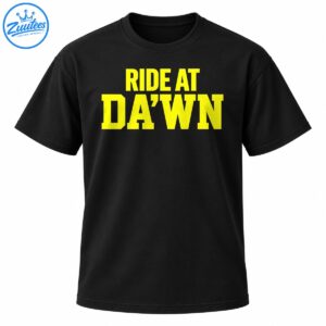Bright yellow RIDE AT DA’WN collegiate lettering in two lines on a dark background