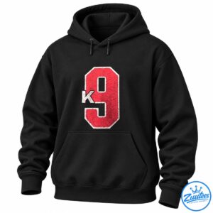 Distressed red number 9 graphic with a cream outline and overlapping cream letter K on a black background.
