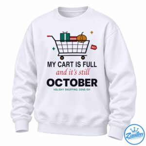 Funny October shopping shirt design with a full cart, wrapped presents, pumpkin, sale tag, and holiday shopping text.