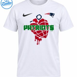 Red dripping grenade-like graphic with distressed green PATRIOTS lettering and navy and red sports-inspired emblems on a shirt.