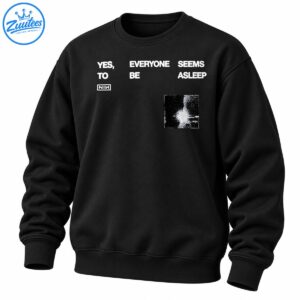 Black graphic shirt design with distressed white YES EVERYONE SEEMS ASLEEP lettering, boxed NIN logo, and grainy monochrome artwork.