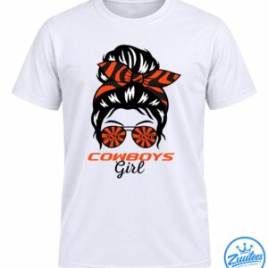 Cowboys Girl Shirt graphic with a black messy bun, orange and black bandana bow, sunburst sunglasses, and bold lettering.