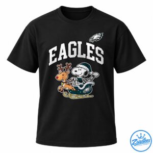 Snoopy in a teal winter outfit rides a sleigh with a red-nosed reindeer beneath bold white EAGLES lettering and an eagle emblem.