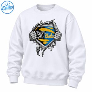Grayscale hands rip open a jagged surface revealing a black Raiders shield and blue and gold UCLA graphic.