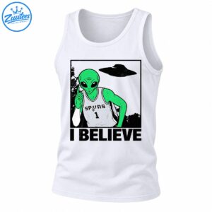 Green alien in a gray SPURS number 1 basketball jersey pointing upward beneath a UFO with bold I BELIEVE text
