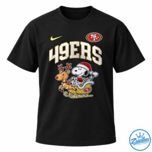 49ers Snoopy shirt design with Snoopy in a Santa suit riding a gold sleigh pulled by a reindeer.