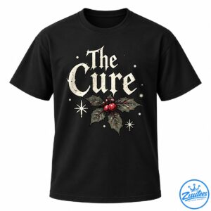 The Cure Gothic Christmas design with distressed ivory lettering, dark holly leaves, red berries, and cream winter stars.