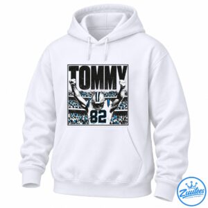 Tommy Balboa football graphic with large black lettering, a player wearing jersey 82, raised fists, and a blue-accented stadium crowd
