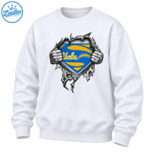 UCLA blue and gold shield with cursive lettering revealed by grayscale hands ripping through jagged material