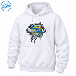 UCLA blue and gold shield with cursive lettering revealed by grayscale hands ripping through jagged material
